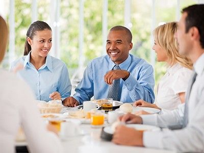 image of members of a young professionals board attending a breakfast meeting